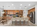 Spacious kitchen featuring a large center island, stainless steel appliances, and ample cabinet space at 26808 N 64Th Ln, Phoenix, AZ 85083