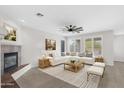 Comfortable living room with a fireplace, stylish furniture, and an open layout at 26808 N 64Th Ln, Phoenix, AZ 85083