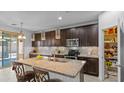 Gourmet kitchen features granite countertops, dark cabinetry, and stainless steel appliances at 2903 E Quenton St, Mesa, AZ 85213