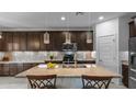 Stylish kitchen with granite counters, stainless appliances, pendant lighting, and dark cabinets at 2903 E Quenton St, Mesa, AZ 85213