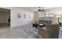 Open living area with plush rug, ceiling fan, and natural light from shuttered windows at 2903 E Quenton St, Mesa, AZ 85213