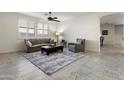 Inviting living room features modern furnishings, neutral color palette and plantation shutters at 2903 E Quenton St, Mesa, AZ 85213