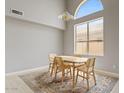 Elegant dining room with a large window, modern chandelier, and a stylish area rug at 4422 E Dry Creek Rd, Phoenix, AZ 85044