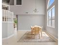 Bright dining room featuring high ceilings, light tile flooring, and a neutral color palette at 4422 E Dry Creek Rd, Phoenix, AZ 85044