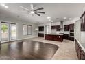 Open concept living area with kitchen, island, stainless steel appliances, and french door access to backyard at 702 E Capricorn Way, Chandler, AZ 85249