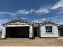 New construction single-story home with a two-car garage and unfinished roof at 7700 W Saddlehorn Rd, Peoria, AZ 85383
