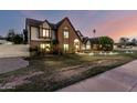 Elegant brick Tudor-style home with a landscaped lawn and inviting arched entryway at 908 N Creston --, Mesa, AZ 85213