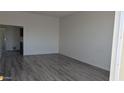 Living room features wood-look floors, neutral walls, and ample natural light at 10039 W Lancaster Dr, Sun City, AZ 85351