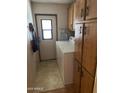 Functional laundry area with cabinets and a washer and dryer at 11596 W Sierra Dawn Blvd # 209, Surprise, AZ 85378