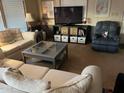 Cozy living room with neutral tones, comfortable seating, and a large television at 11596 W Sierra Dawn Blvd # 209, Surprise, AZ 85378