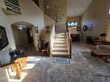 Inviting entryway with soaring ceilings and a staircase leading to the upper level of the home at 12237 W Sherman St, Avondale, AZ 85323