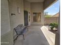 Cozy covered porch featuring a bench and security door for a relaxing outdoor welcome at 12237 W Sherman St, Avondale, AZ 85323
