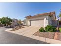 Well-maintained home with a spacious two-car garage, complemented by desert landscaping and a neighborhood street at 1226 E Presidio Rd, Phoenix, AZ 85022
