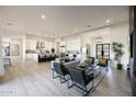 Open-concept living area featuring tile floors, a modern kitchen, and stylish furniture at 1250 E Smokehouse Trl, Phoenix, AZ 85085