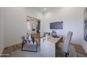 Cozy office with neutral decor, a work desk and a large TV at 1250 E Smokehouse Trl, Phoenix, AZ 85085