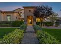 Inviting walkway leading to home's front entrance, flanked by manicured greenery and landscape lighting at 17937 E Colt Ct, Queen Creek, AZ 85142