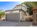 Charming exterior with a two-car garage, mature landscaping, and decorative accents at 19511 N 76Th Ave, Glendale, AZ 85308