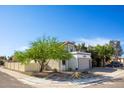 View of charming single-Gathering home with lush landscaping, and a two-car garage at 19511 N 76Th Ave, Glendale, AZ 85308