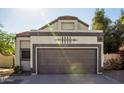 Two-car garage with decorative detailing and ample parking space in front of home at 19511 N 76Th Ave, Glendale, AZ 85308