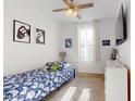 Bright bedroom with a blue patterned bed, gaming decor, and a large window for natural light at 1972 N Loretta Pl, Casa Grande, AZ 85122