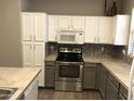 Beautiful kitchen boasts modern appliances, spacious countertops, and ample cabinet storage at 21214 N 80Th Ln, Peoria, AZ 85382
