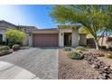 Charming single-story home featuring a brick driveway, two-car garage, and desert landscaping at 21930 N 29Th St, Phoenix, AZ 85050