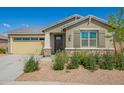 Single-story home boasts stone accents, desert landscaping, and a covered front entry under a clear blue sky at 2464 N Morrison Ave, Casa Grande, AZ 85122