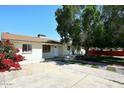 Inviting single-story home with a well-maintained front yard and mature shade tree at 2614 W Greenway Rd, Tempe, AZ 85282