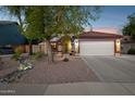 Inviting single-story home with desert landscaping, arched entrance, tile roof and a two-car garage at 263 S Del Rancho --, Mesa, AZ 85208