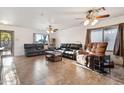 Bright living room with tile floors, comfortable leather seating, ceiling fans and natural light at 263 S Del Rancho --, Mesa, AZ 85208