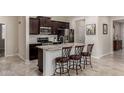 Modern kitchen features a large island with seating, stainless steel appliances, and dark wood cabinets at 2731 E Cherry Hill Dr, Gilbert, AZ 85298