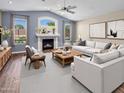 Bright living room with fireplace, large windows, modern furniture, and stylish decor at 29227 N 44Th St, Cave Creek, AZ 85331