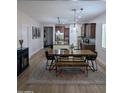 Open-concept dining room features sleek floors, stylish lighting, and is adjacent to the gourmet kitchen at 3085 E Patrick St, Gilbert, AZ 85295