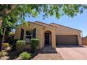 Charming single-Gathering home featuring an arched entryway and a landscaped front yard with mature shade trees at 3085 E Patrick St, Gilbert, AZ 85295