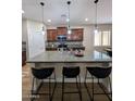 A gourmet kitchen island with granite countertops, pendant lighting and seating for casual dining at 3085 E Patrick St, Gilbert, AZ 85295