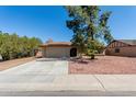 Inviting single-story home with a well-manicured front yard, a shade tree, and a convenient two-car garage at 3124 W Taro Ln, Phoenix, AZ 85027