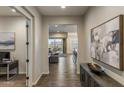 Inviting foyer with hardwood floors and an open view into the living room and outdoor patio at 32237 N 133Rd Dr, Peoria, AZ 85383