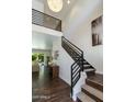 Bright foyer with wood flooring, a modern staircase, and soaring ceilings creates an open and airy entrance at 3229 E Campbell Ave, Phoenix, AZ 85018