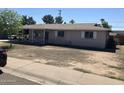 Single story home with overgrown yard and covered front porch at 3419 W Glenn Dr, Phoenix, AZ 85051