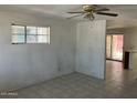 Living room features tiled floors, white walls and natural lighting at 3419 W Glenn Dr, Phoenix, AZ 85051