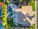 Aerial view of a home with a private backyard oasis, including a pool, patio, and lush landscaping at 3623 S Agave Way, Chandler, AZ 85248