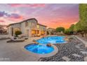 Luxurious backyard featuring a sparkling pool, hot tub, lounge chairs, and lush landscaping at 3623 S Agave Way, Chandler, AZ 85248