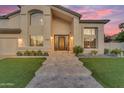 Stunning front elevation showcasing a grand entrance with a decorative door and manicured green lawn at 3623 S Agave Way, Chandler, AZ 85248