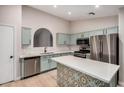 Modern kitchen featuring stainless steel appliances, sleek white countertop and accent cabinets at 3885 E Lambeth Pl, San Tan Valley, AZ 85140