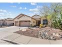 Charming home featuring a three-car garage and a beautifully xeriscaped front yard at 3933 E Meadowview Dr, Gilbert, AZ 85298