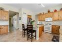 Kitchen features tile flooring, granite countertops, kitchen island and white appliances at 3933 E Meadowview Dr, Gilbert, AZ 85298