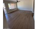Spacious living room featuring modern flooring and large windows for natural light at 4309 E Alta Mesa Ave, Phoenix, AZ 85044