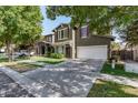 Two-story home featuring green exterior, red shutters, a well-kept lawn and long driveway at 4337 E Vaughn Ave, Gilbert, AZ 85234