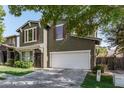 Charming two-story home featuring green exterior, red shutters, well-kept lawn and a two car garage at 4337 E Vaughn Ave, Gilbert, AZ 85234