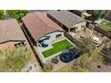 Aerial view of a home's backyard, showcasing a trampoline and artificial grass at 4617 W Cottontail Rd, Phoenix, AZ 85086